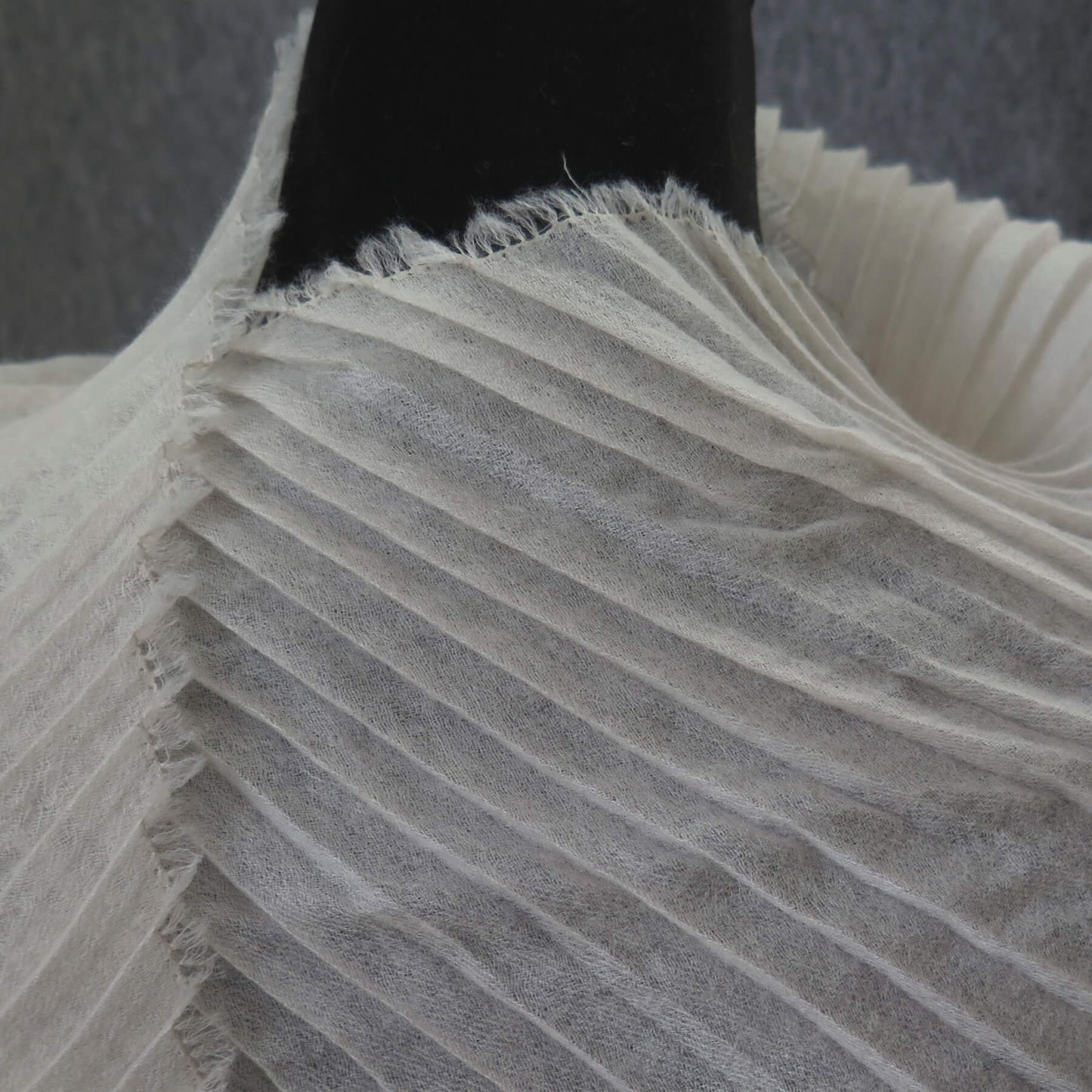 Delicate pleated Cashmere wrap. Light cream with fringing and angled ends