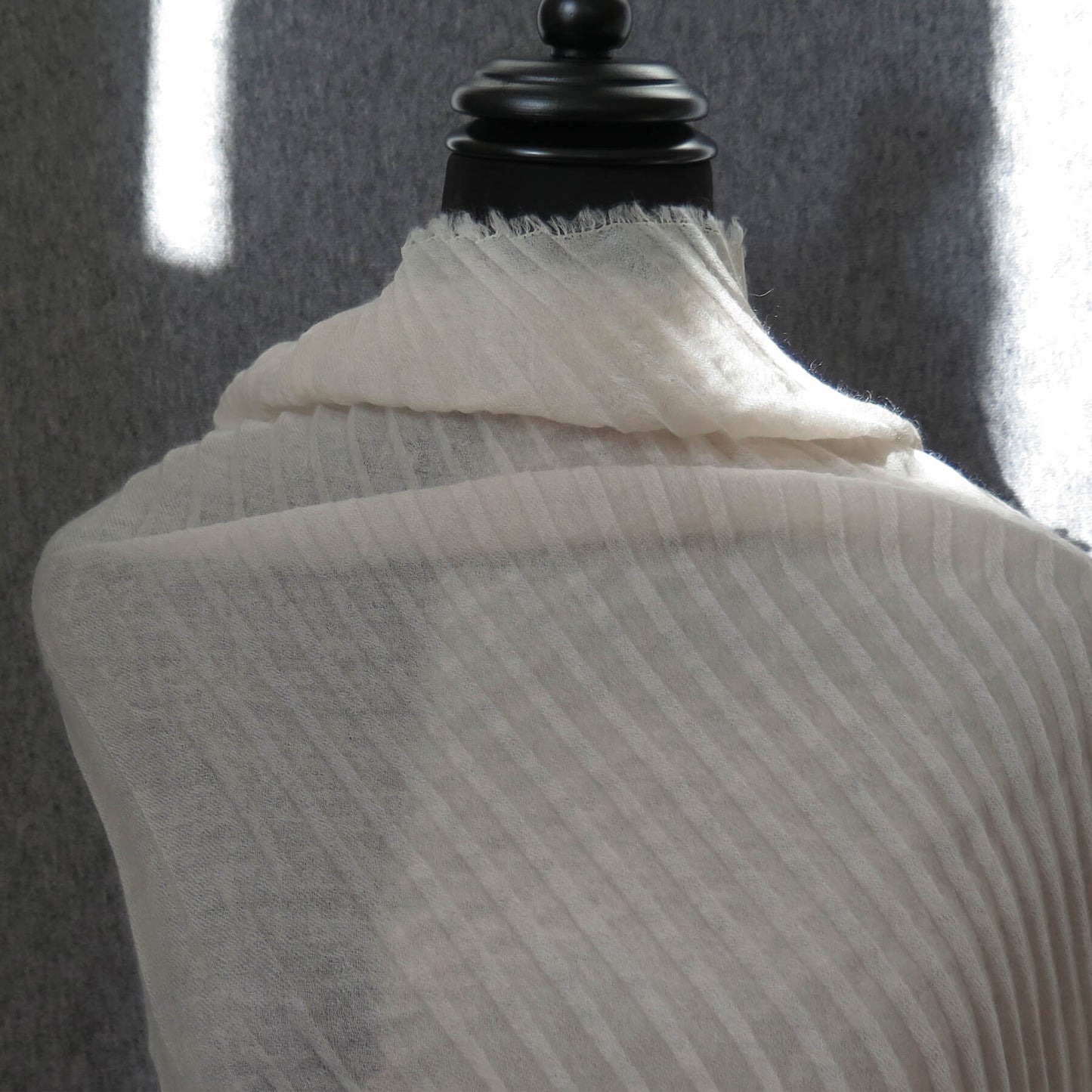 Delicate pleated Cashmere wrap. Light cream with fringing and angled ends