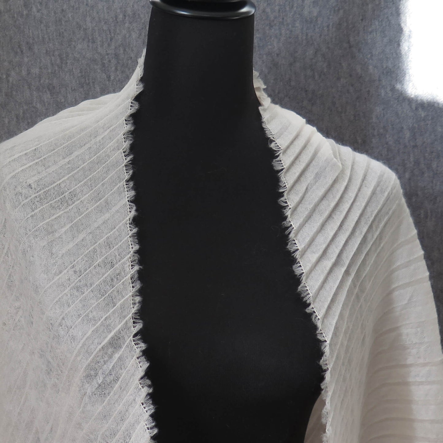 Delicate pleated Cashmere wrap. Light cream with fringing and angled ends