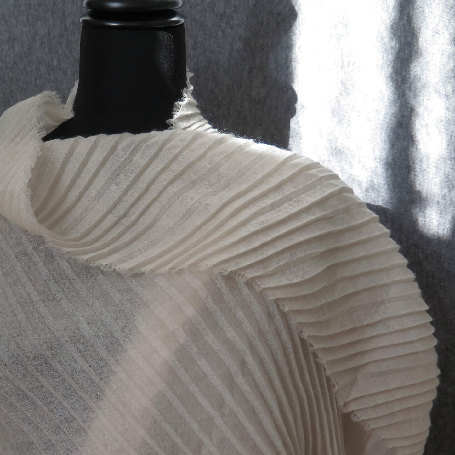 Delicate pleated Cashmere wrap. Light cream with fringing and angled ends