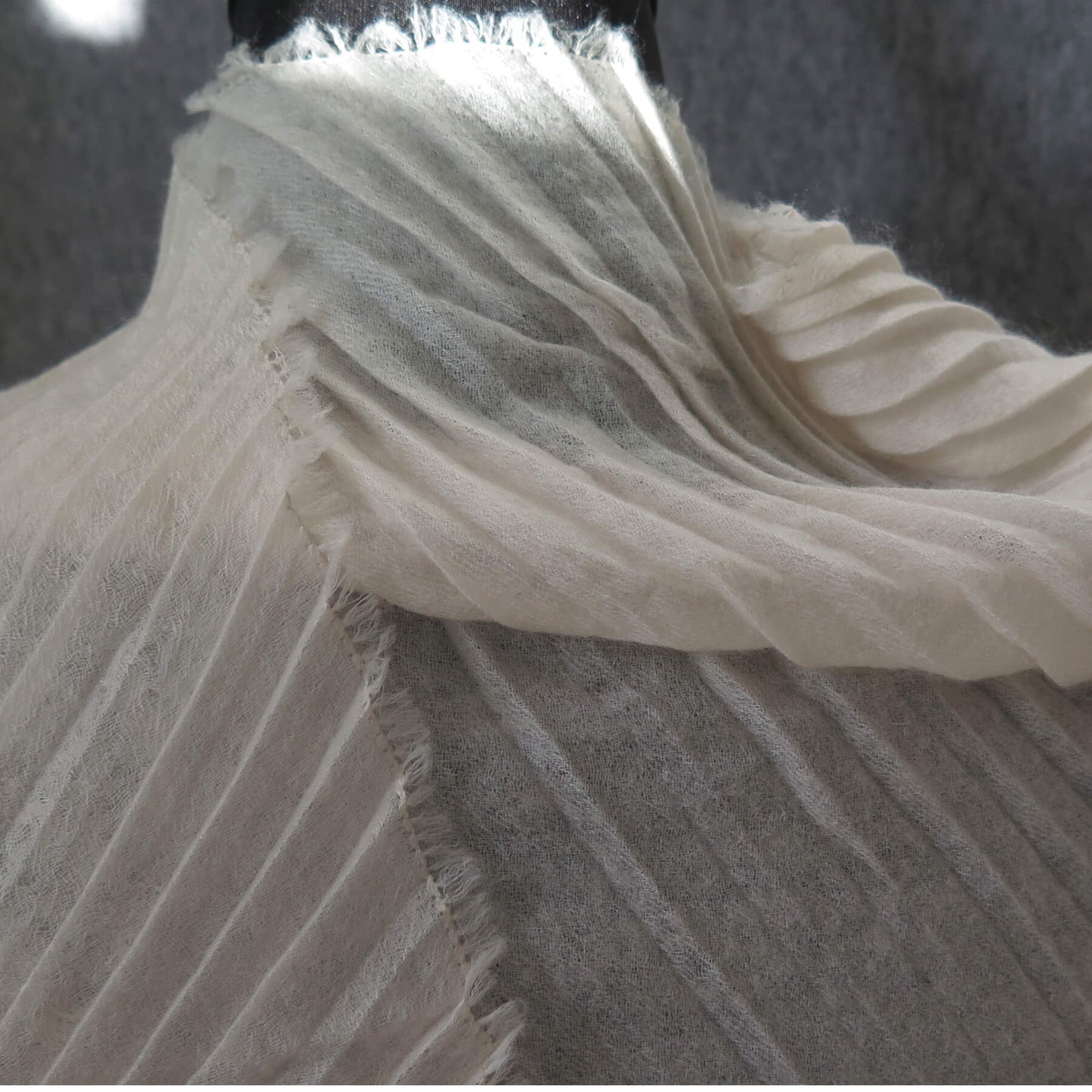 Delicate pleated Cashmere wrap. Light cream with fringing and angled ends