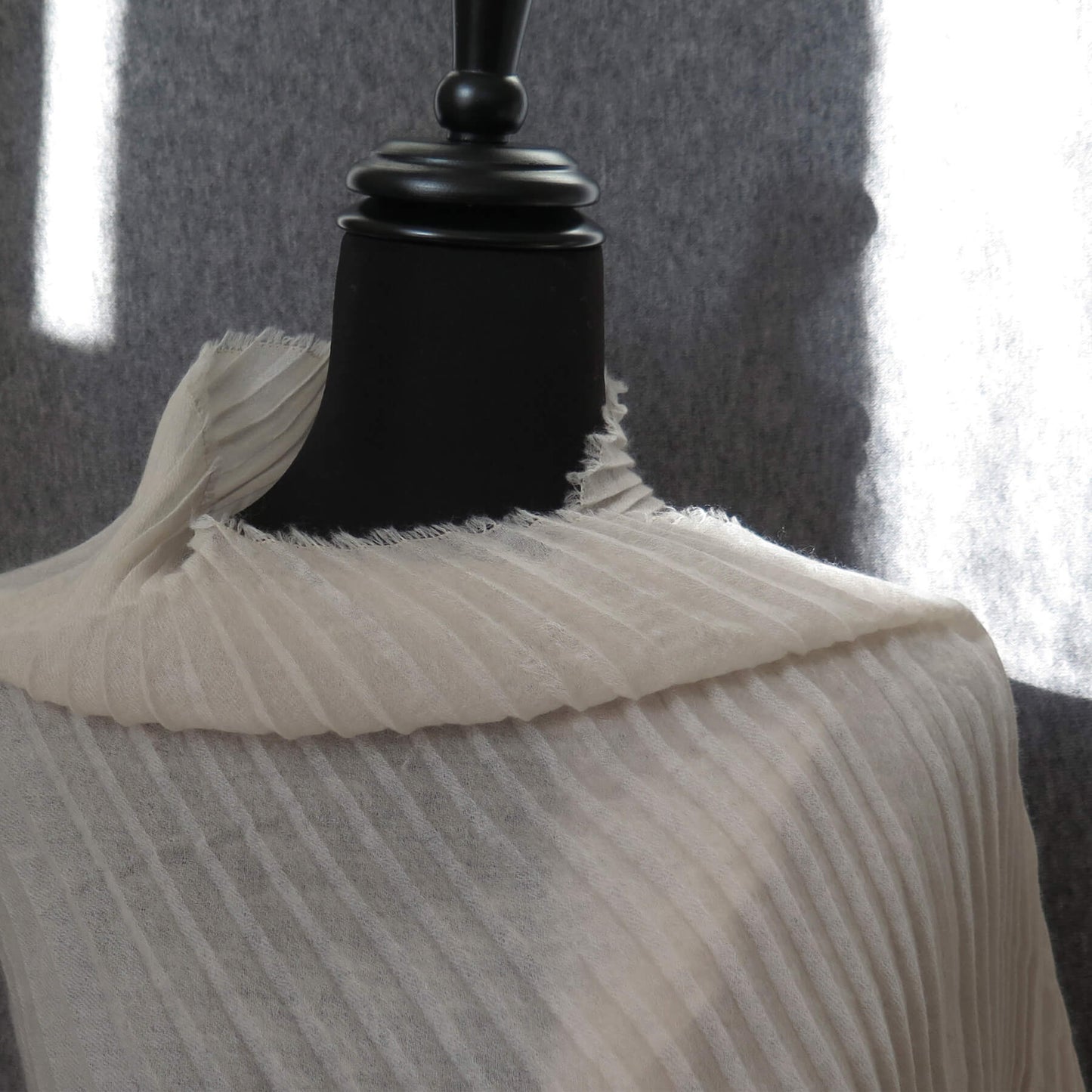 Delicate pleated Cashmere wrap. Light cream with fringing and angled ends